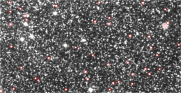 This picture presents a part of an image of the sky in FITS format. Red circles indicate stars chosen by means of the described software in this article.